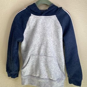 Grey and navy hoodie with striped sleeve